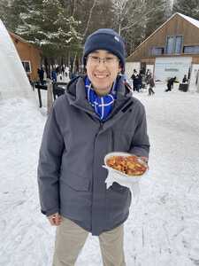 Asian man with poutine on ice