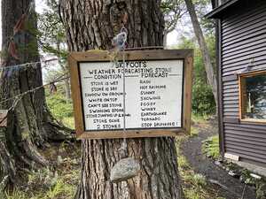 Stone hanging on rope in front of sign