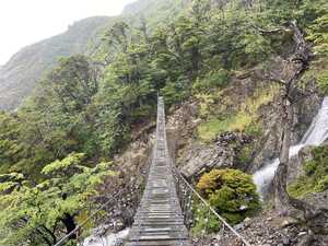 Suspension bridge over waterfall