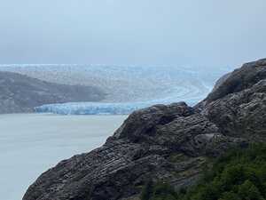 Glacier in lake behind rocks