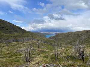 Blue lake behind grassy hills