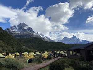 Campground with yellow tents in front of mountain