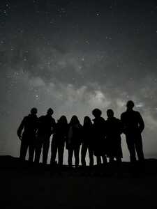 Silhouette of group in front of stars
