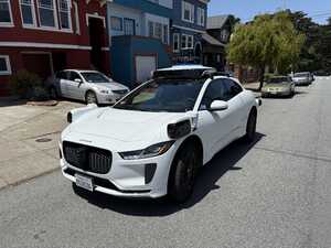White car with sensors on neighbood block
