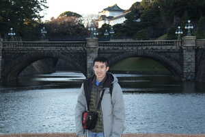 Man in front of bridge