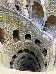 Looking into a round stone staircase