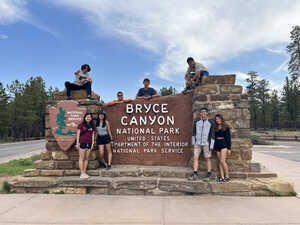 Group picture in front of park sign