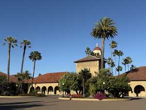 College campus courtyard with palm trees and blue sky