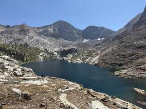Alpine lake with rock walls behind