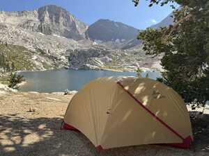 Tent in front of lake and mountain