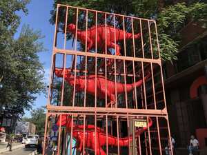 Three dinosaur statues in cages
