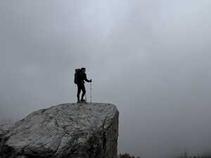 Hiker on rock in the fog