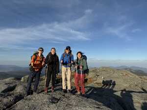Four hikers on top of mountain