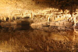 Lake inside a cave mirroring rock formation on roof