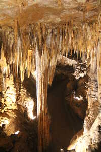 Looking down into cavern with walkway by large pillar of rock