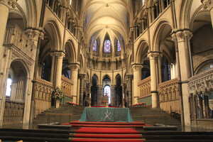 Cathedral interior with elaborate stone furnishings and cloth-covered communion table