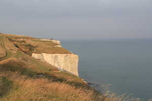 White cliffs by the sea with yellow grass on top