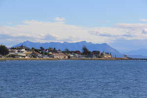 City across shore with mountain behind