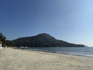 Forested mountain behind beach