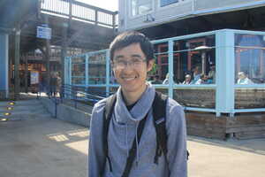 Asian man in gray jacket