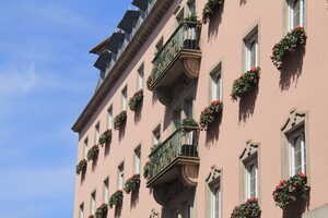 Pink house with flower boxes in windows