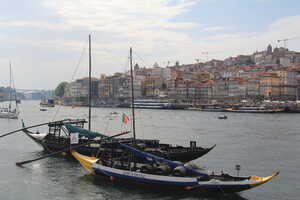 Boats in river in front of old city