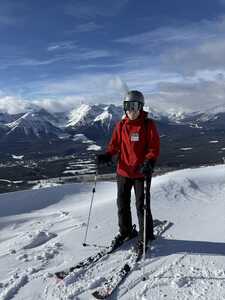 Skier in red in front of mountains