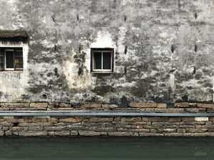 Window on wall in front of canal