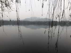 Misty mountain behind lake