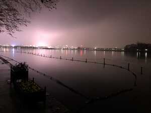 Lake at night with city behind