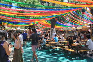 Public benches on blue floor with colorful streamers above
