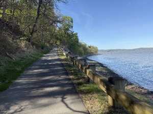 Paved cycle path by river