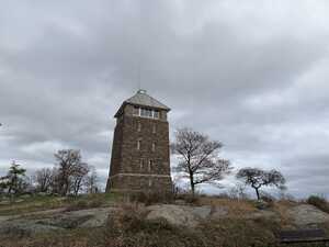 Brick tower against cloudy sky