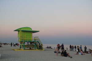 Beach at sunset with green life guard tower