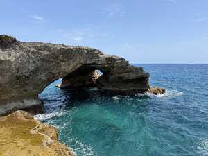 Sea arch above blue waters
