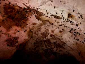 Bats on cave roof with red lighting