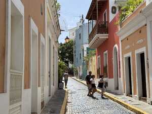 Narrow cobble street lined with colorful houses