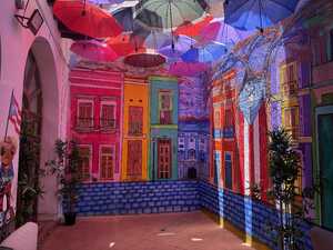 Colorful painted houses with umbrellas above