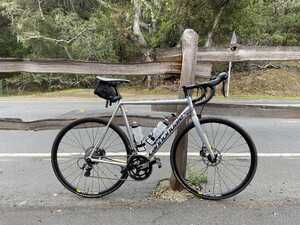 Rental bike against a wooden fence