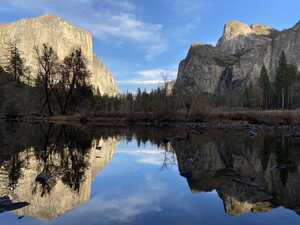 Reflecting pond in front of granite cliffs