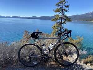 Bicycle against bushes in front of Lake Tahoe