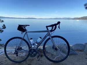 Bicycle in front of rocks in front of lake