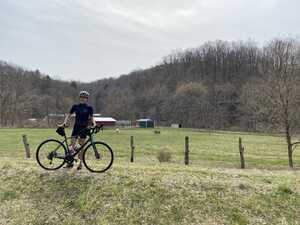 Cyclist in front of field