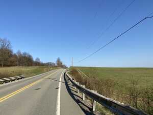 Road through countryside field