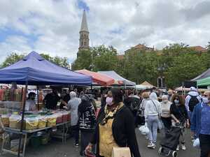 Crowded market with church in background