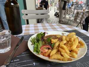 Plate with beef stew, vegetables, and French fries