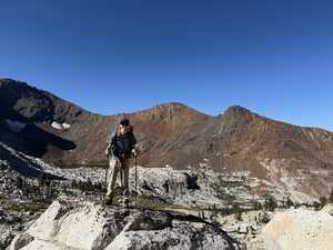 Asian hiker in front of brown mountain