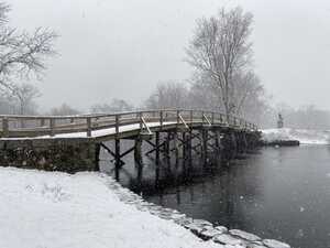 Wooden bridge over snowy river