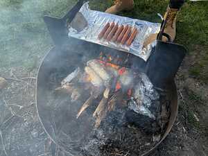 Cooking food over campfire