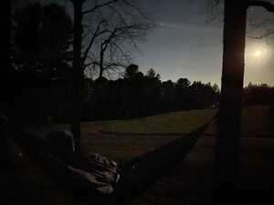 Man in hammock watching moon